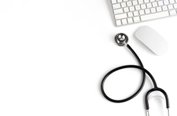 Stethoscope beside mouse and keyboard